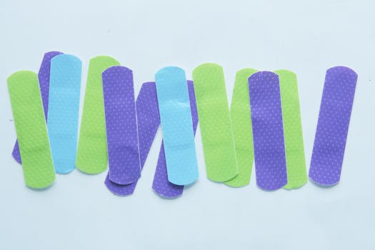 Colorful band-aids arranged on a white surface, perfect for health and safety themed projects.