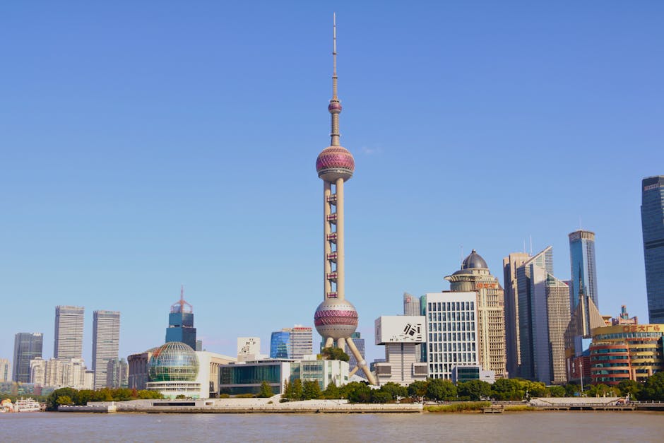 Capture of Shanghai's iconic skyline featuring the Oriental Pearl Tower during a clear day.